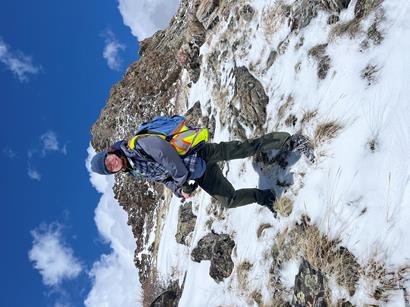 Image of student atop a mountain.