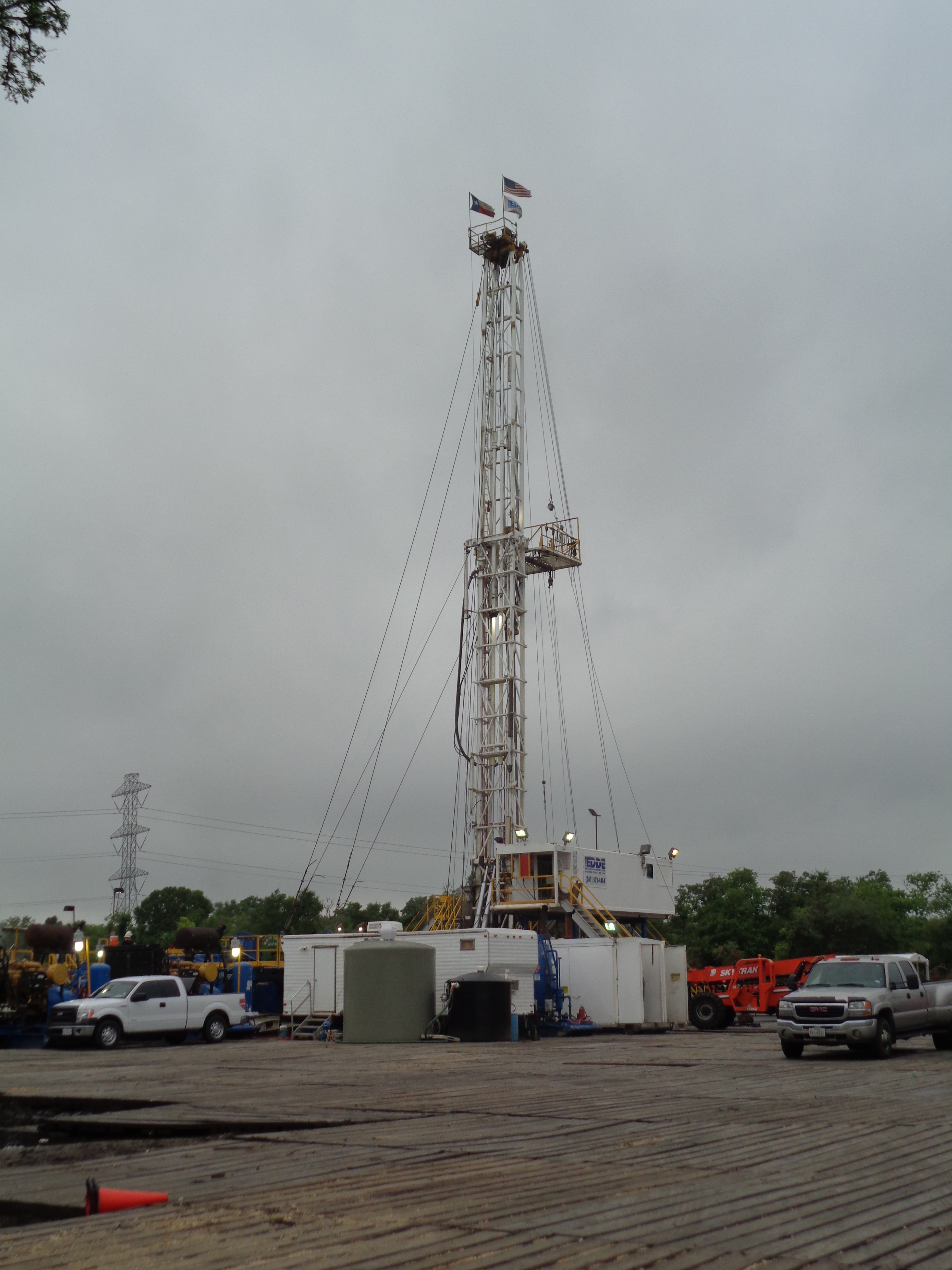 Large construction tower with flags mounted on the top.