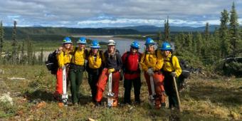 Group of students in front of lake.